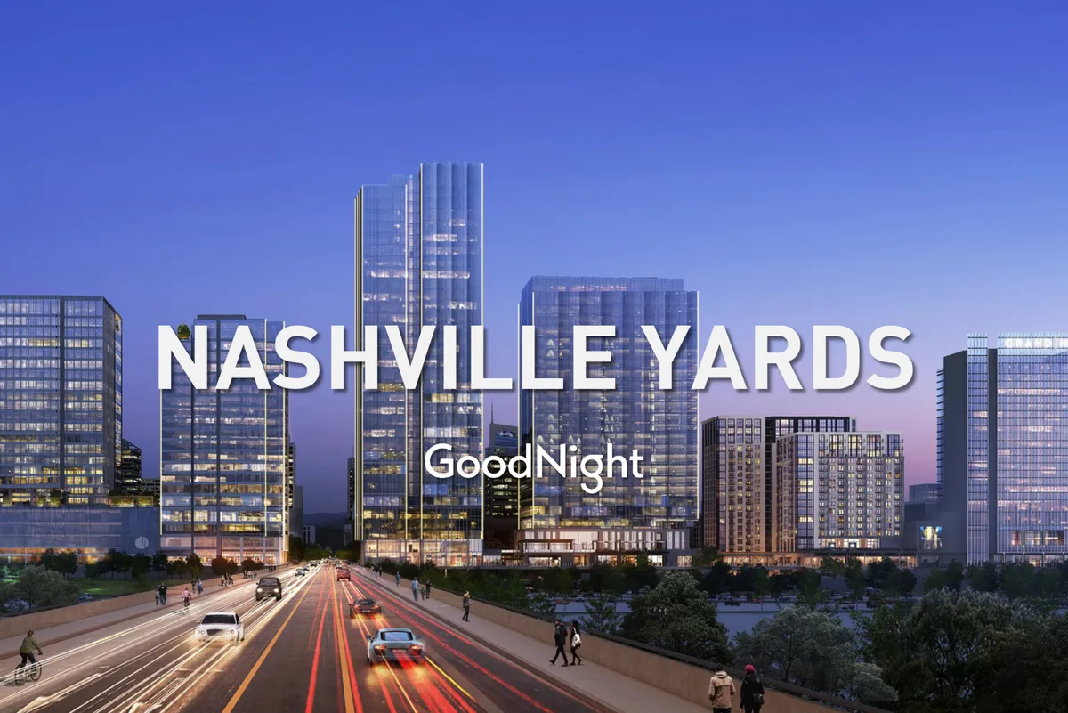 A vibrant exterior shot showcasing Nashville's dynamic cityscape with soaring skyscrapers, a bustling highway, and energetic city lights. The scene captures the spirit of urban life, hinting at the city's proximity to business hubs and its lively atmosphere.