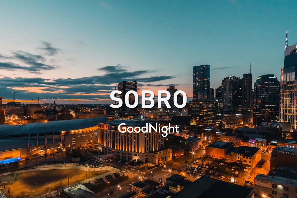 A wide, panoramic view of Nashville’s city skyline at sunset. The glowing sky casts an inviting light over urban streets, capturing the energy and allure of Nashville nightlife and local attractions.