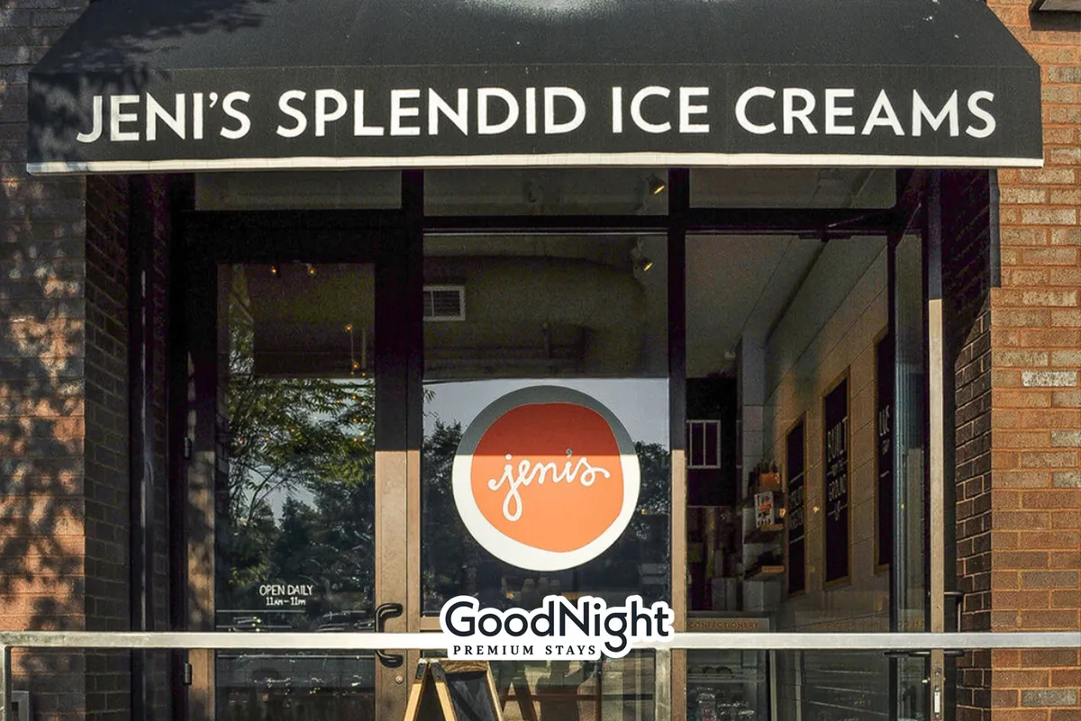 A cheerful exterior shot of an ice cream shop storefront, complete with an inviting awning and a visible logo. The scene feels welcoming, suggesting social outings and fun treats, ideal for couples and families enjoying a sweet stop on their stroll.